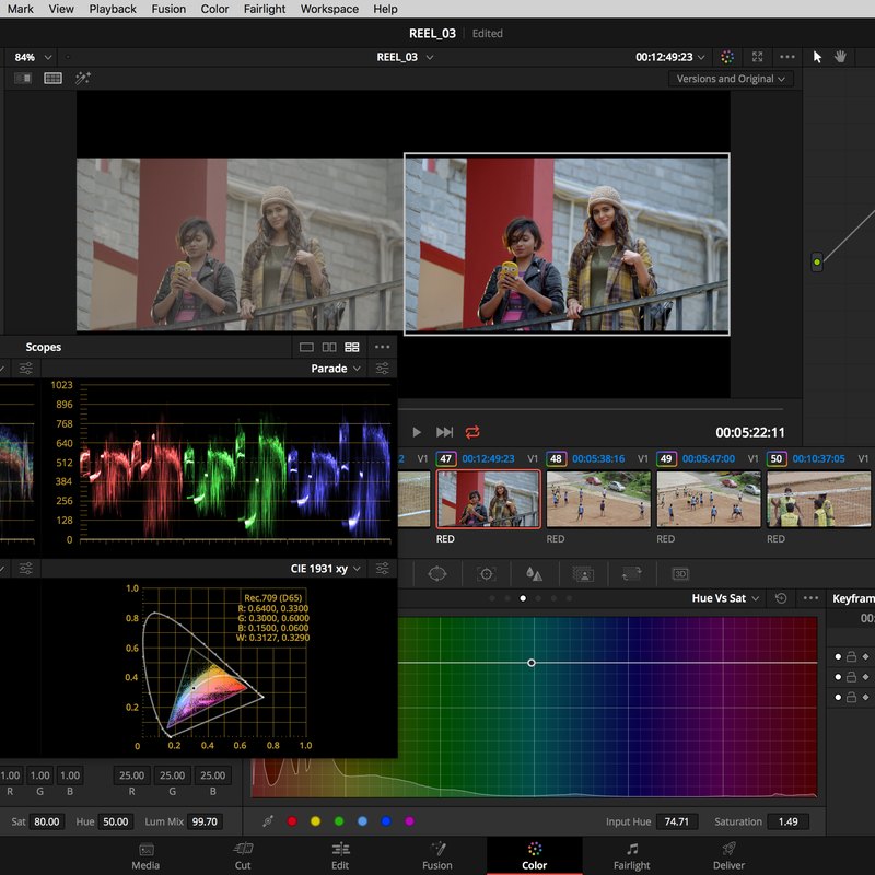 The DaVinci Resolve colour page: one shot open in the viewer with the graded and ungraded versions side by side, parade and CIE scopes below it, and a hue-versus-saturation curve open.